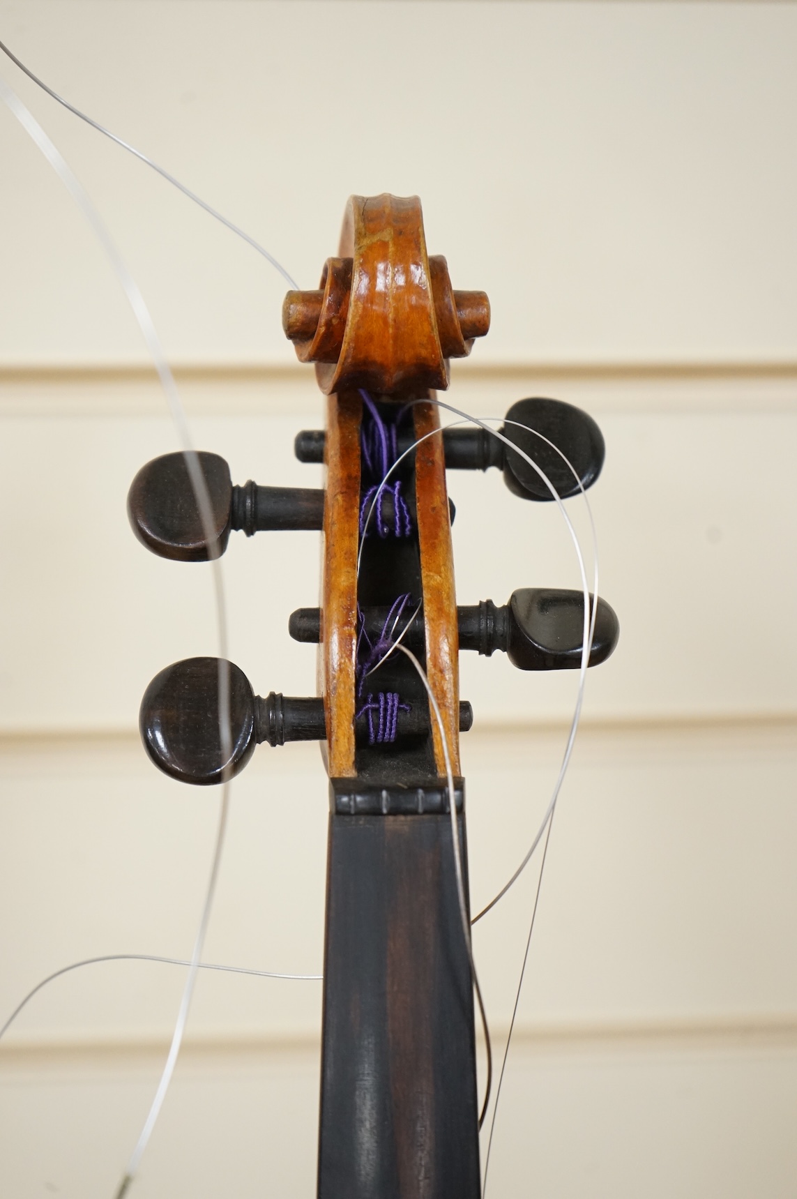 Four violins; a German Dresden violin, together with further two German violins, and a Saxony violin, three in cases or the remains of cases.